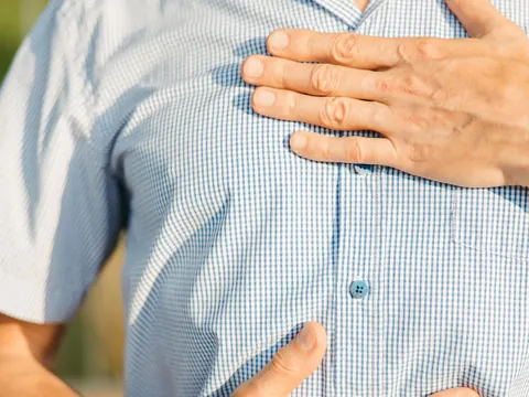 A hand pressed on the chest in pain