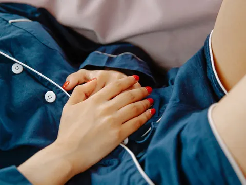 Hands pressed on the stomach in pain